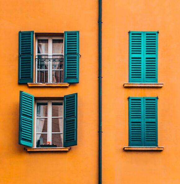 two colourful open windows next to two colourful closed windows